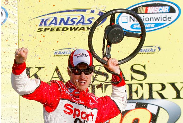 Joey Logano celebrates in Victory Lane at Kansas Speedway after earning his second win of 2010 and eighth win in the NASCAR Nationwide Series Kansas Lottery 300. Credit: Jason Smith/Getty Images for NASCAR
